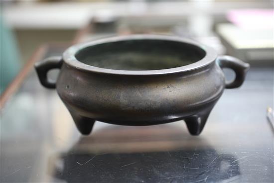 A Chinese brown patinated bronze ding censer, Xuande six character mark, probably 17th/18th century, width 21cm